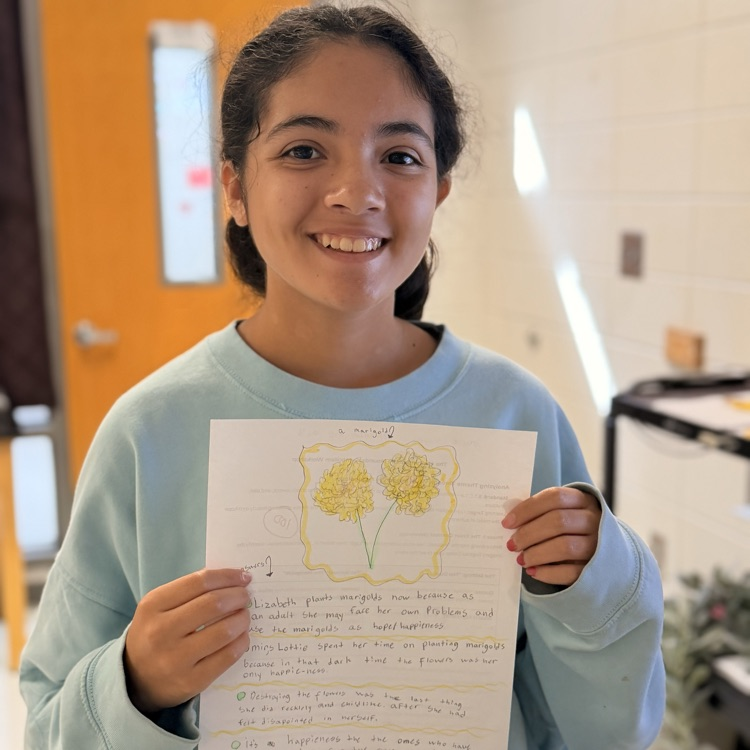 student holding work 