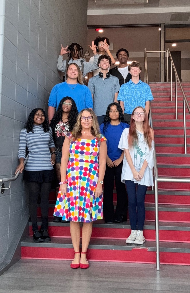 Teacher and students dressed in Twister colors and dots