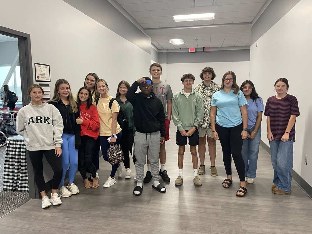 Students dressed in red, blue, green, and yellow