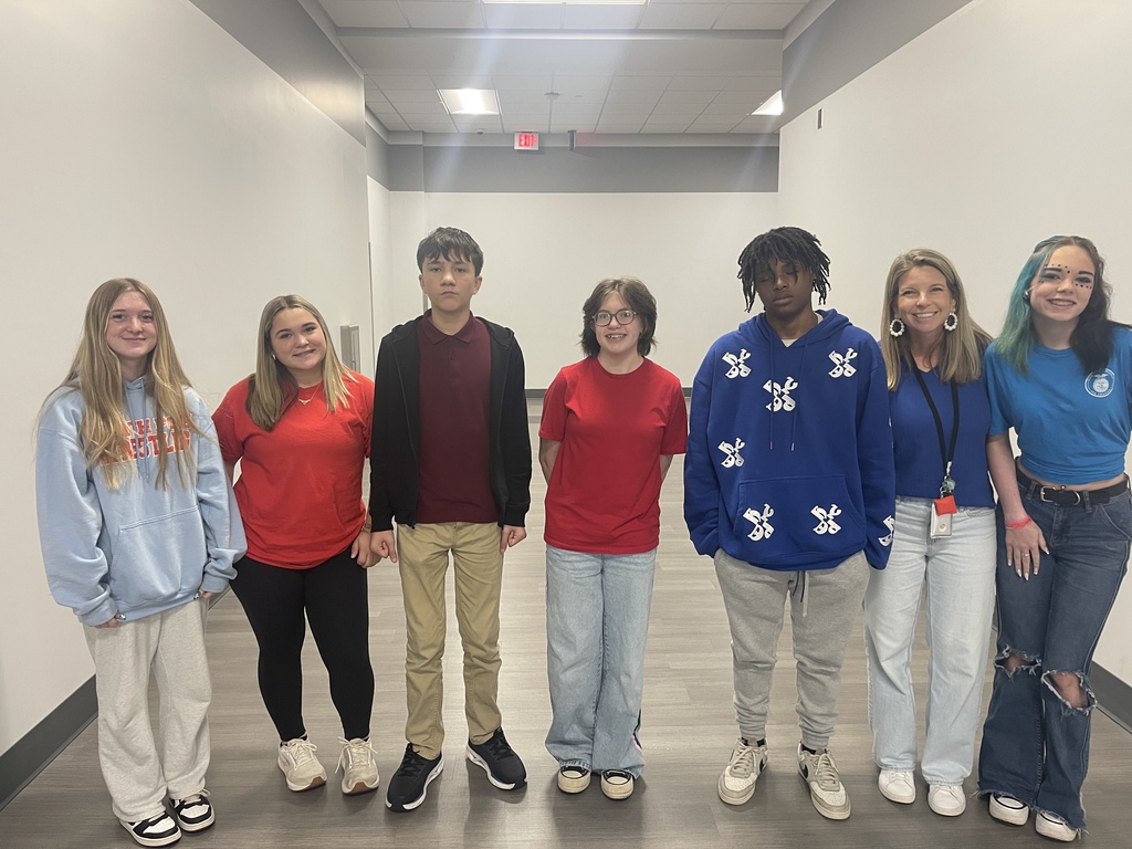 Teacher and students dressed in twister colors
