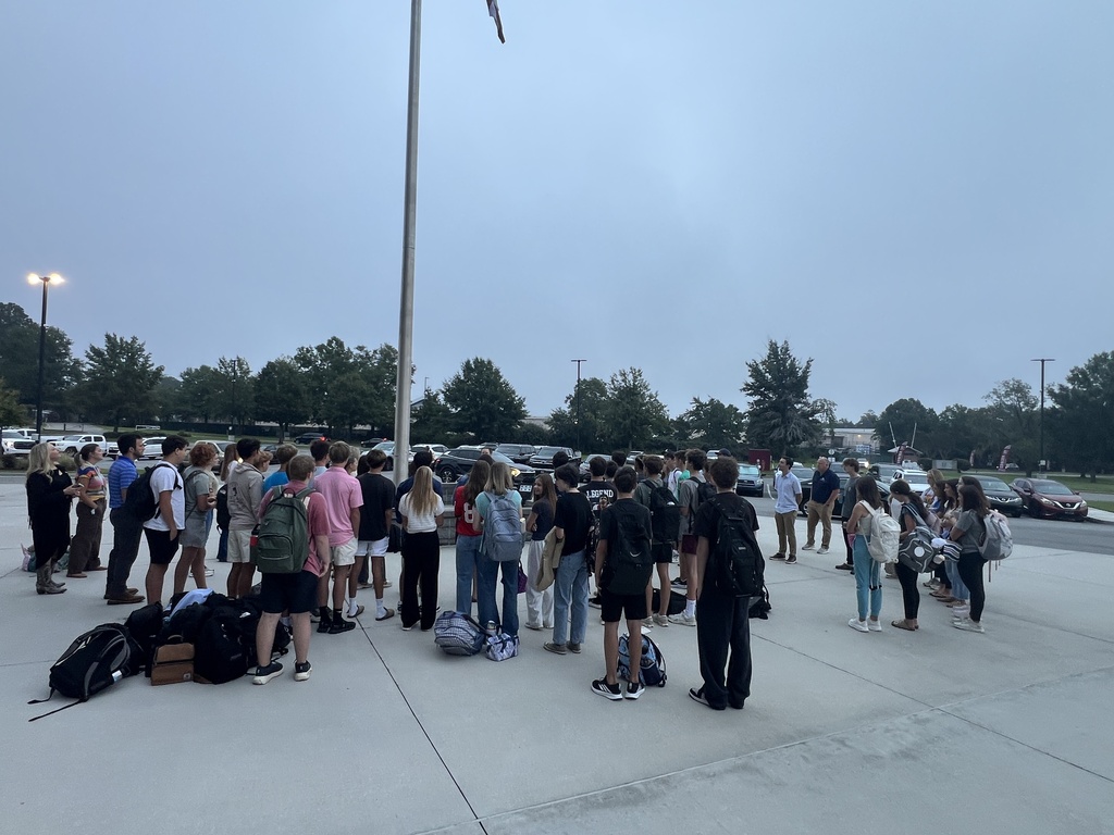 a group of students and teachers who chose to meet at the flagpole for prayer.