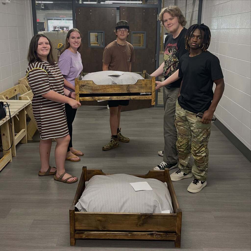Friends Fur Life members and construction students with beds built for dogs