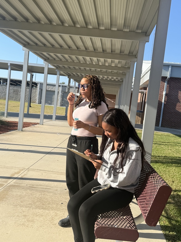 Student observing and taking notes