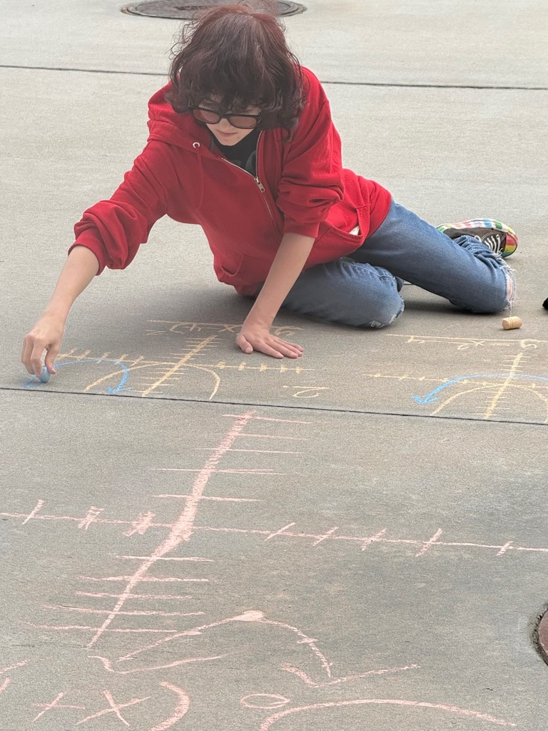 Student graphing on the sidewalk
