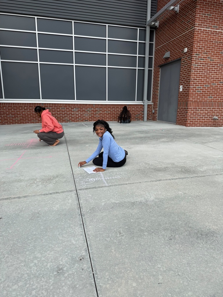 Students drawing graphs on the sidewalk