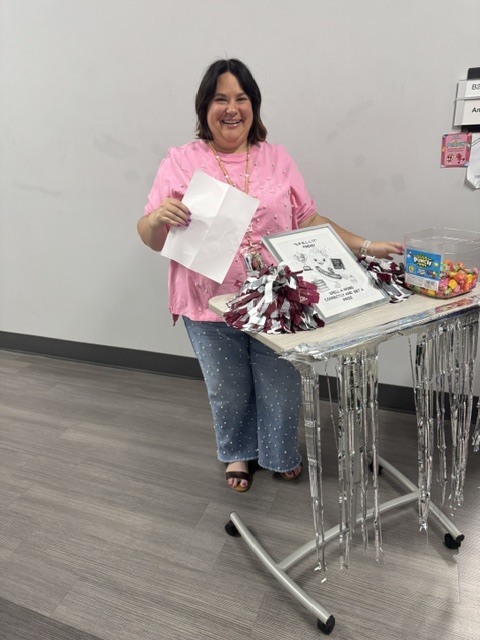 Mrs. New set up with her prize cart and spelling word list