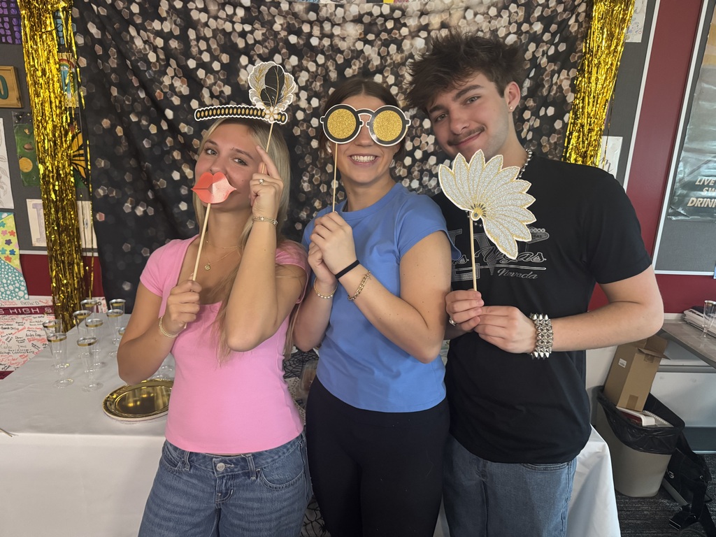 Students posing with photo booth props