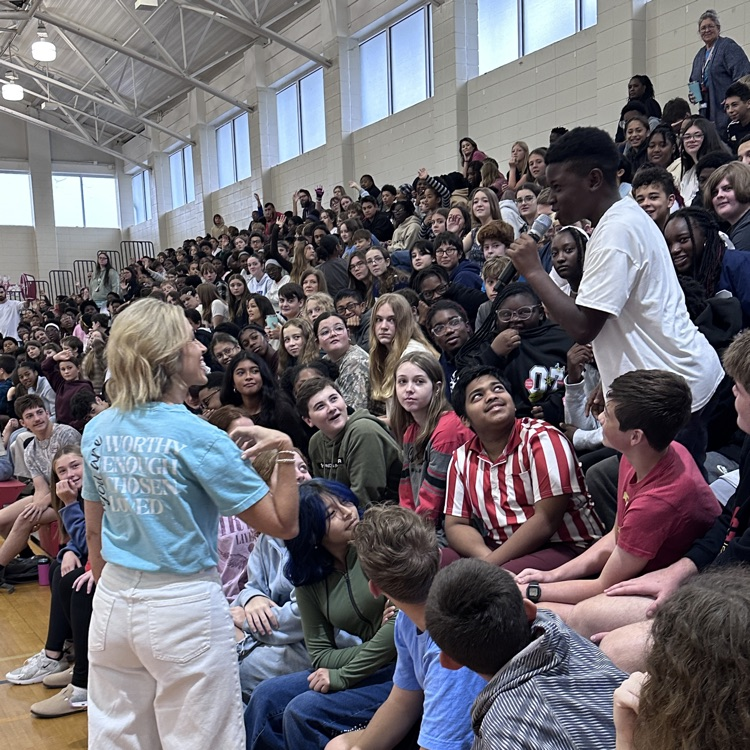 student answering question during assembly