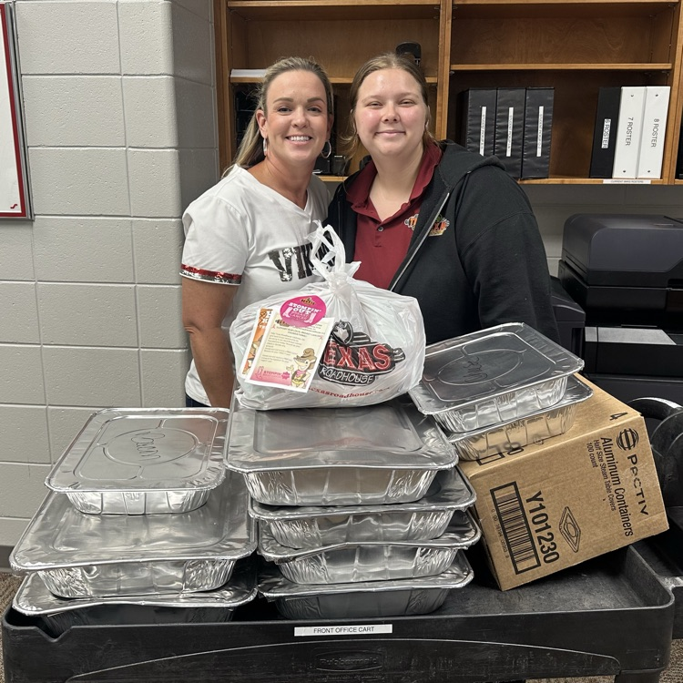 Mrs. Carswell and Texas Roadhouse employee posing with potatoes