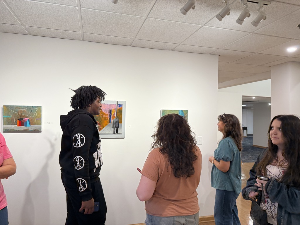 Students viewing art exhibits