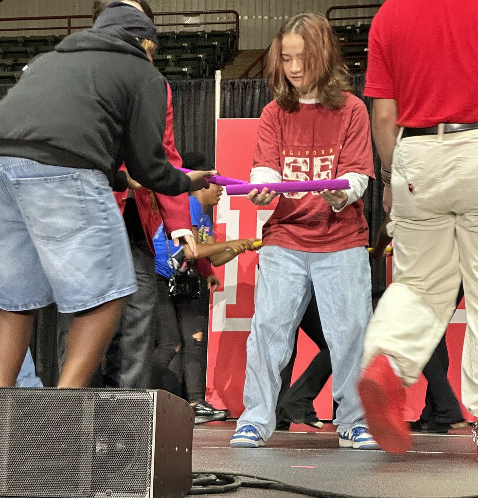 Students participating in a challenge on stage