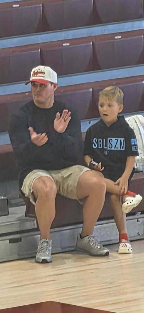 Coach Carter cheering on the Volleyball team in the first round of playoffs