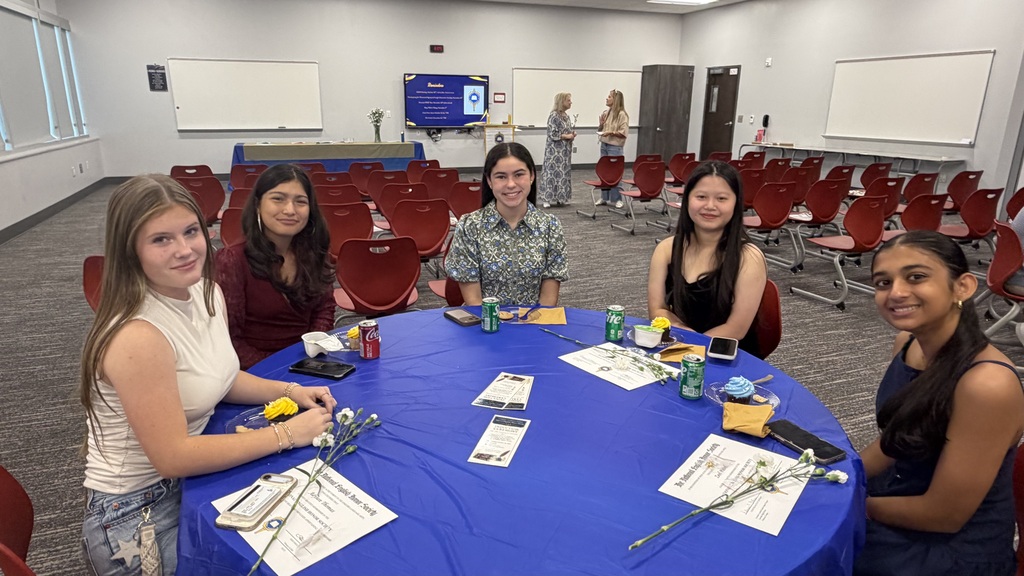 5 NEHS members at a table at the ceremony
