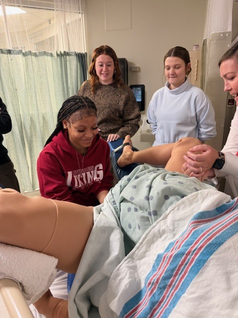 Students practicing on a medical dummy