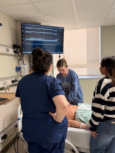 Student working with a medical dummy patient