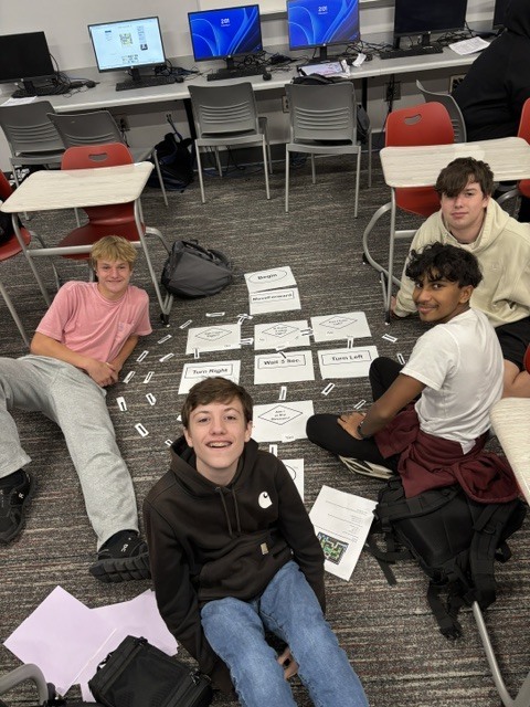Students analyzing algorithms and flow charting