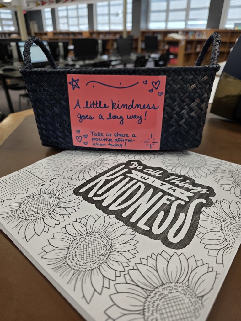 A basket with a sign that says a little kindness goes as long way