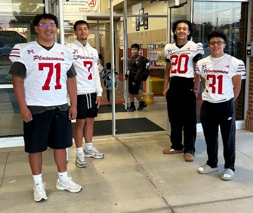 football players greeting students