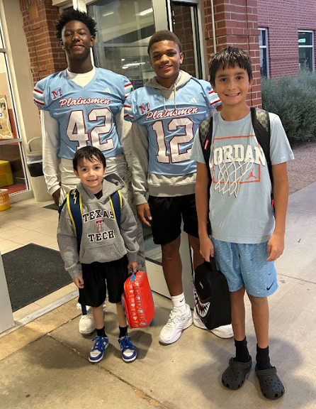 MHS Football Players greeting students and staff