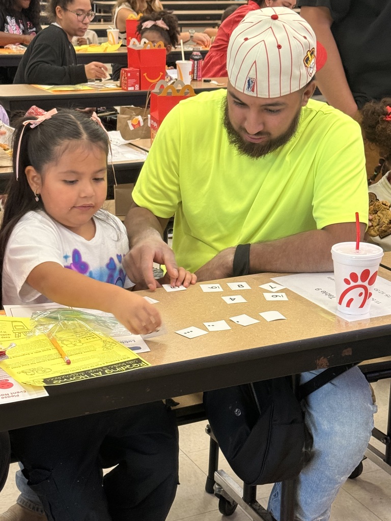 dad and child playing game together in the cafeteria