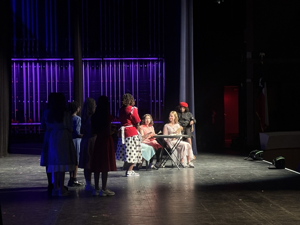 students performing on stage