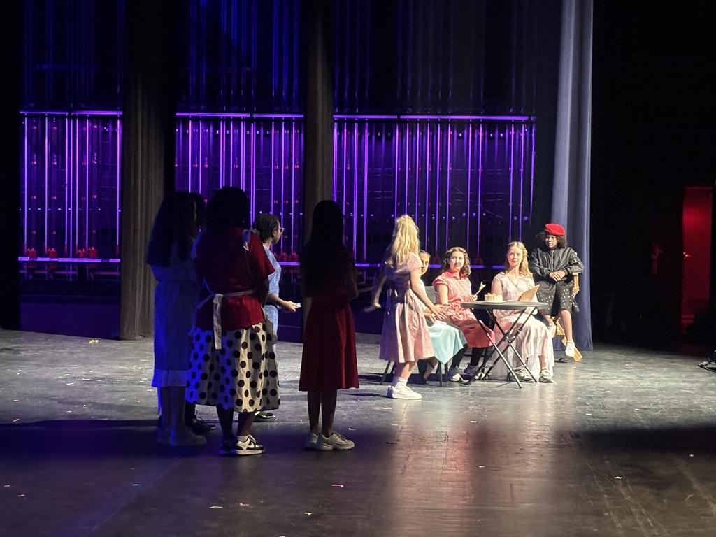 students performing on stage