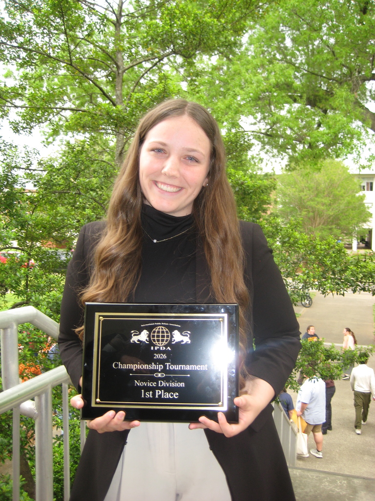 alumna with trophy