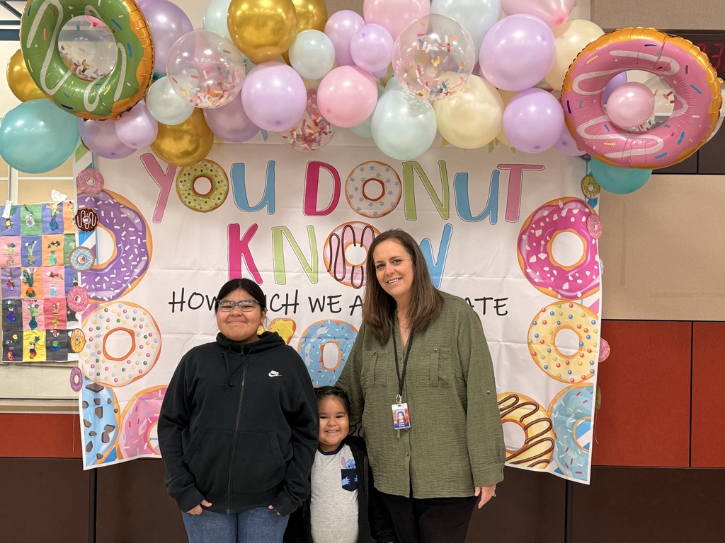 principal and students at donut breakfast
