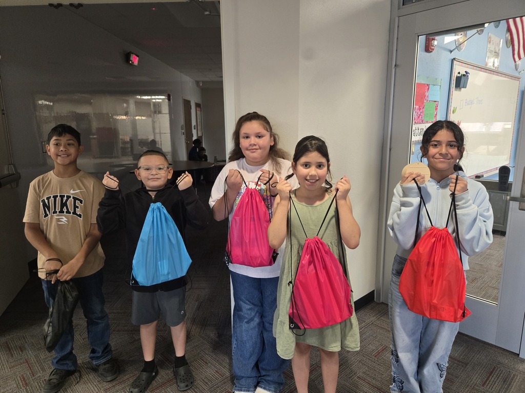 Students receiving a donated backpack.