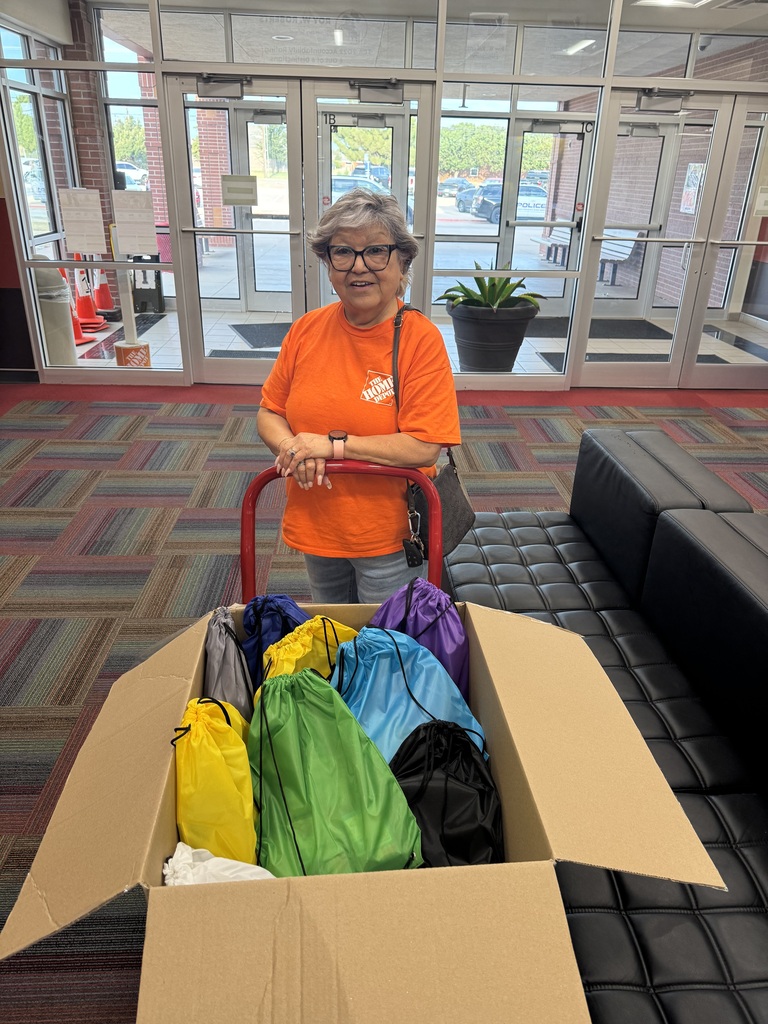 Lady holding backpack donation box.