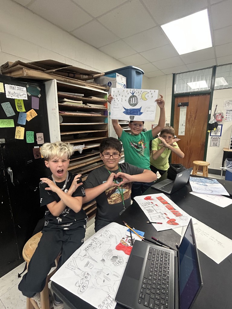students  posing with artwork
