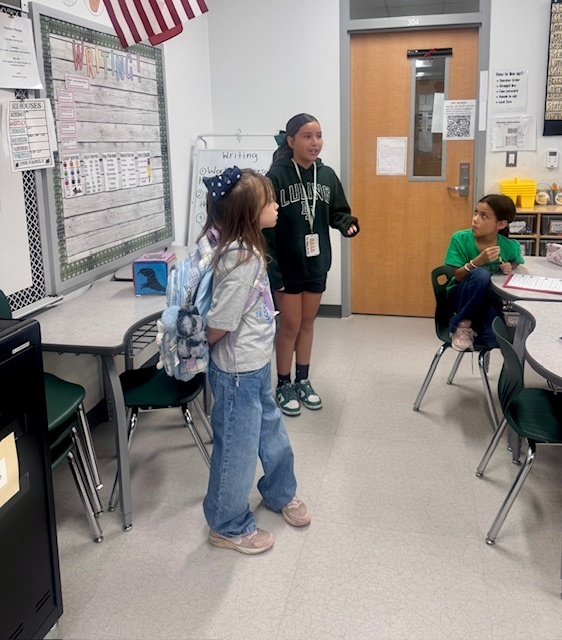 StuCo President introducing a new student to her class