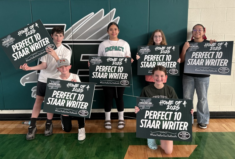 students holding yard sign 