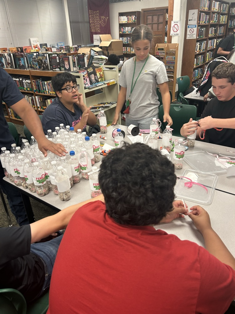 student making pink out items