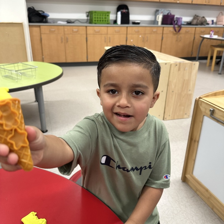 student holding playdough in a cone