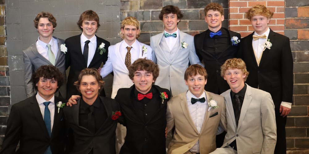 students pose at prom 