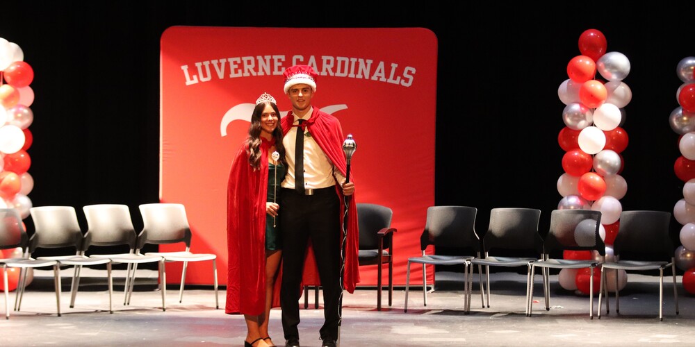 king coy thone and queen macie edstrom pose on stage