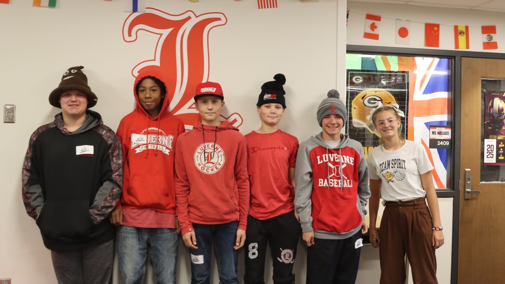 Students pose with their hats on for hat day