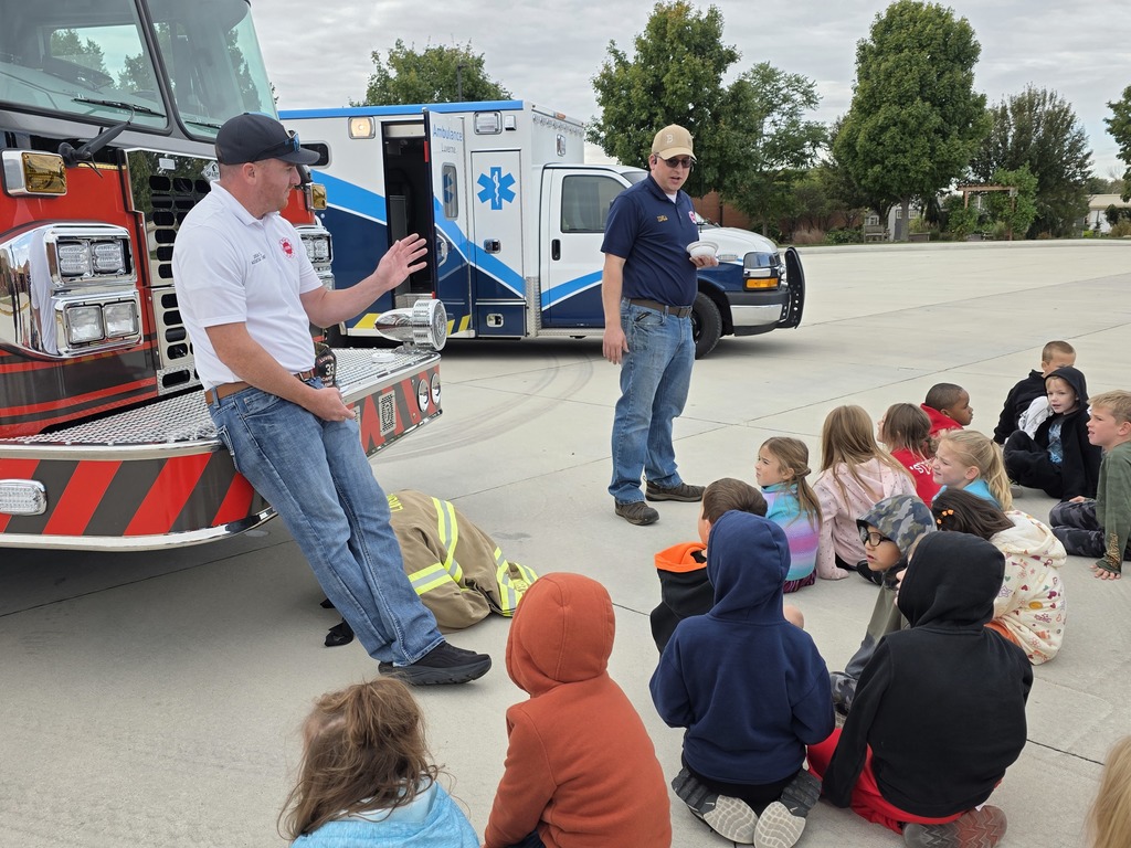 Students listen as local volunteer firefighters explain how to keep yourself safe from fires as well as show all of their firefighter tools!