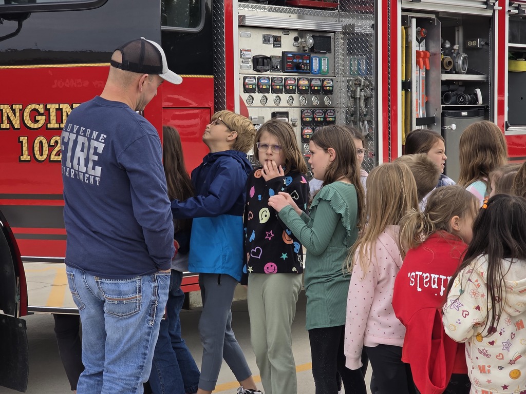 Students listen as local volunteer firefighters explain how to keep yourself safe from fires as well as show all of their firefighter tools!