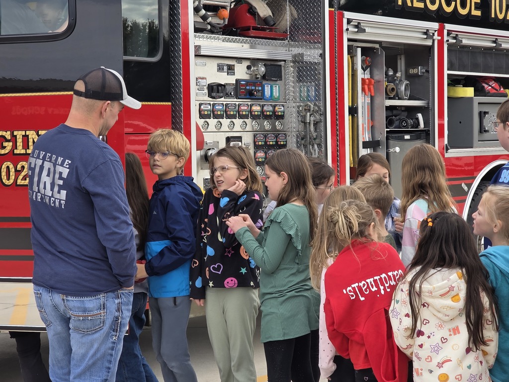 Students listen as local volunteer firefighters explain how to keep yourself safe from fires as well as show all of their firefighter tools!
