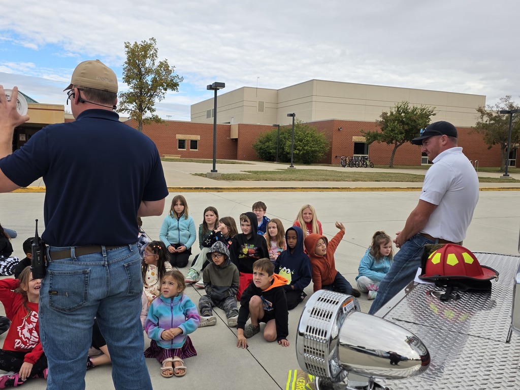 Students listen as local volunteer firefighters explain how to keep yourself safe from fires as well as show all of their firefighter tools!