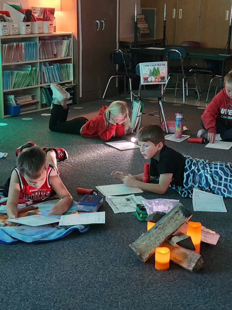 Camping Day reading with flashlights.