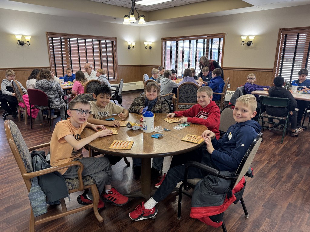 4th graders playing Holiday Bingo and visiting with residents at the Mary Jane Brown Home.