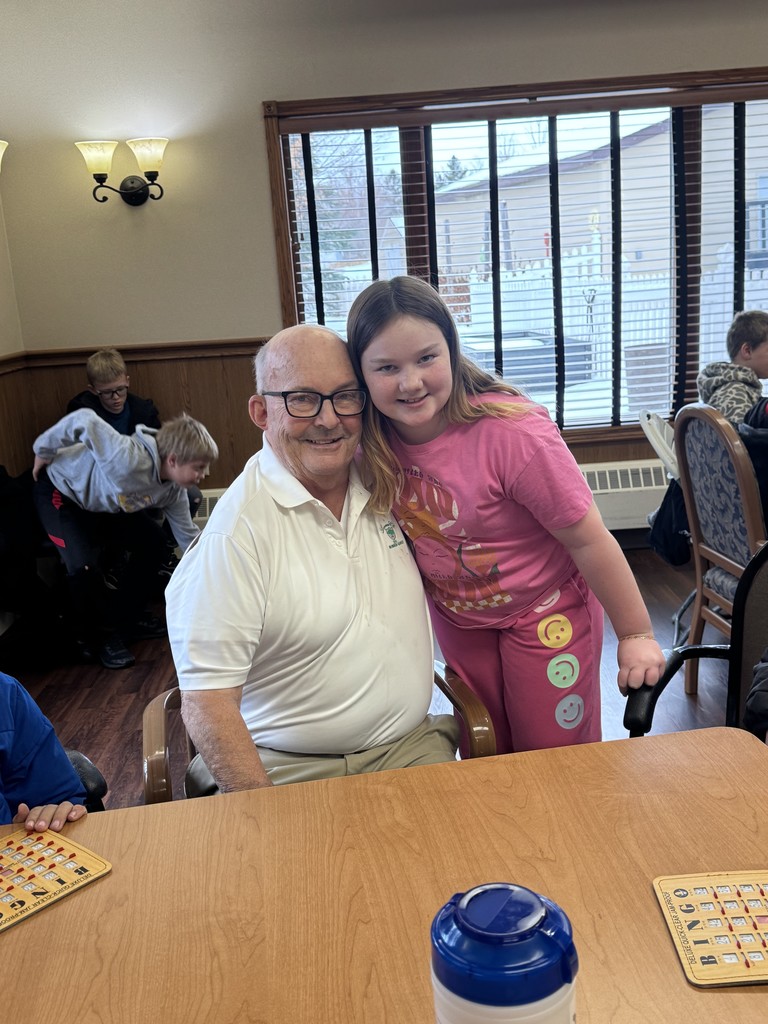 4th graders playing Holiday Bingo and visiting with residents at the Mary Jane Brown Home.