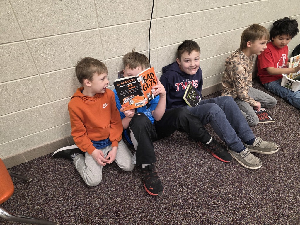 4th graders reading to 1st graders.