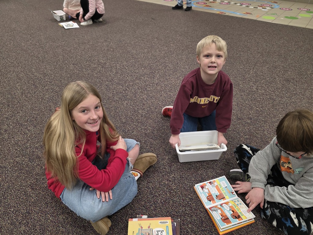 4th graders reading to 1st graders.