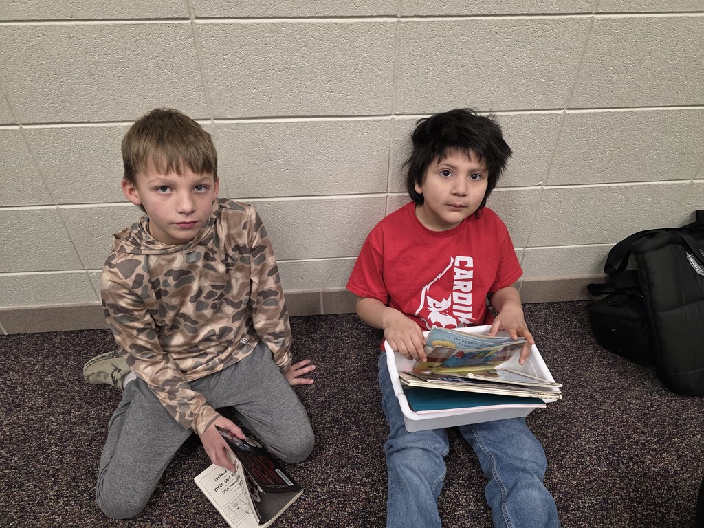 4th graders reading to 1st graders.