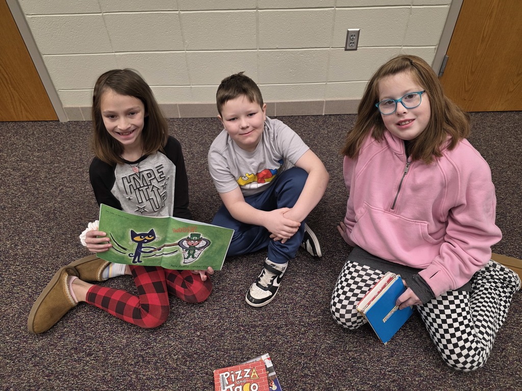 4th graders reading to 1st graders.