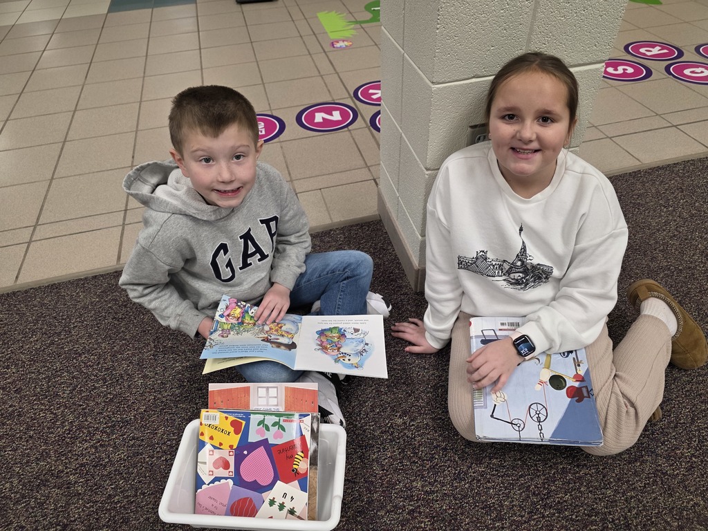 4th graders reading to 1st graders.